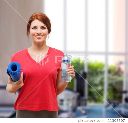 smiling girl with bottle of water after exercising smiling girl with bottle of water after exercising 11308507