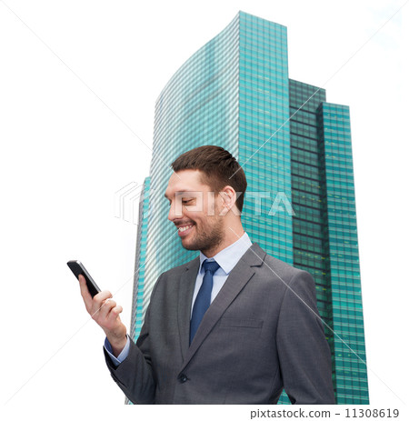 young smiling businessman with smartphone 11308619