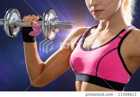 close up of sporty woman with heavy steel dumbbell close up of sporty woman with heavy steel dumbbell 11308621
