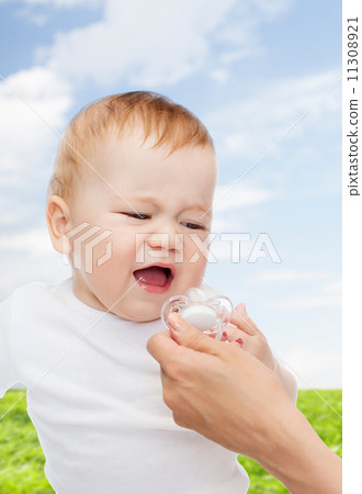 crying baby with dummy 11308921