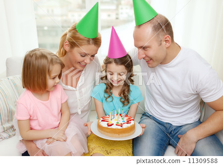 smiling family with two kids in hats with cake smiling family with two kids in hats with cake 11309588