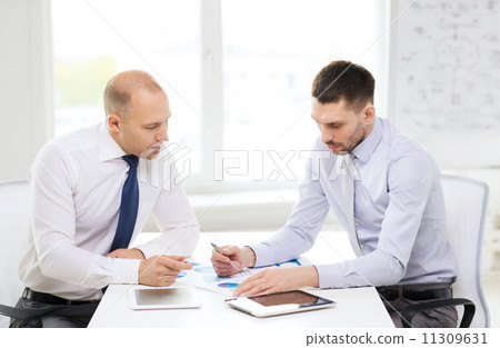 two serious businessmen with tablet pc in office 11309631