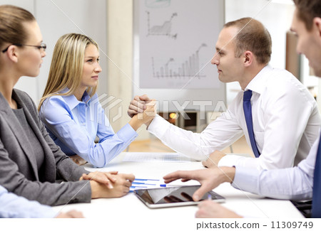 businesswoman and businessman arm wrestling 11309749