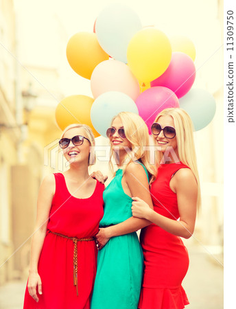 beautiful girls with colorful balloons in the city 11309750