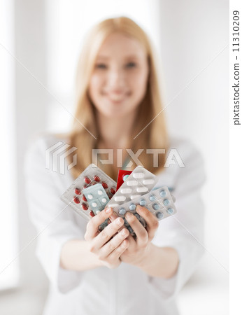 female doctor with packs of pills 11310209