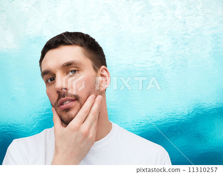 beautiful calm man touching his face beautiful calm man touching his face 11310257
