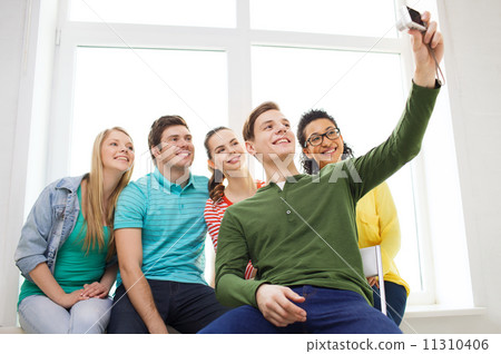 five smiling students taking picture with camera 11310406