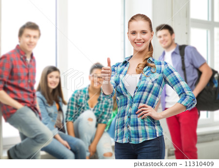 young woman in casual clothes showing thumbs up 11310409