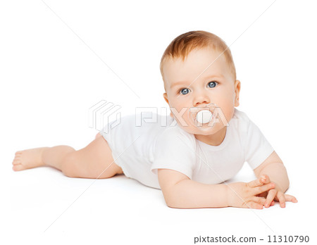smiling baby lying on floor with dummy in mouth smiling baby lying on floor with dummy in mouth 11310790
