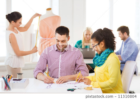 smiling fashion designers working in office 11310804