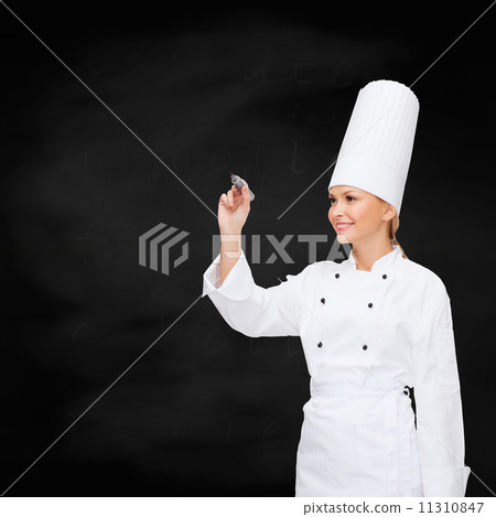 smiling female chef writing something on air smiling female chef writing something on air 11310847