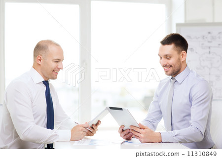 two smiling businessmen with tablet pc in office 11310849