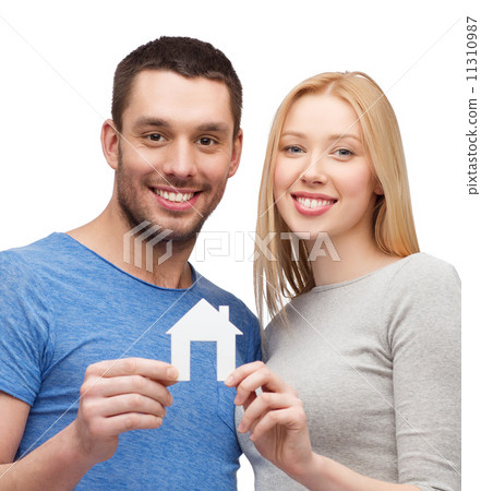 smiling couple holding white paper house 11310987