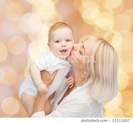 happy mother kissing smiling baby happy mother kissing smiling baby 11311007
