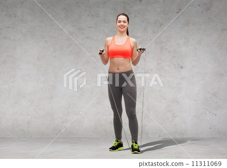 sporty woman with skipping rope sporty woman with skipping rope 11311069