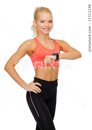 smiling woman with heart rate monitor on hand 11311246