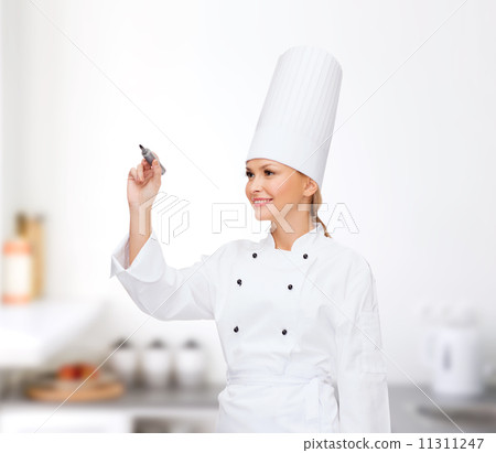 smiling female chef writing something on air 11311247