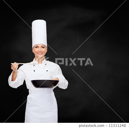 smiling female chef with pan and spoon 11311248