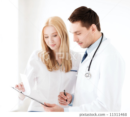 two doctors writing prescription 11311468