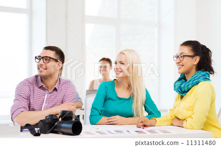smiling team with photocamera working in office smiling team with photocamera working in office 11311480