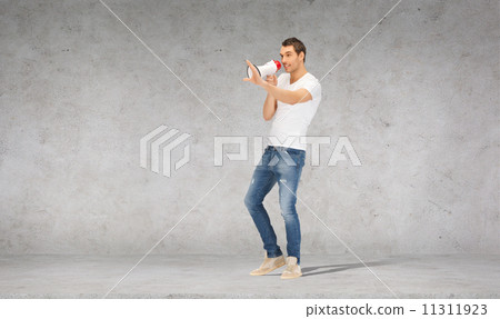 handsome man with megaphone over concrete wall 11311923