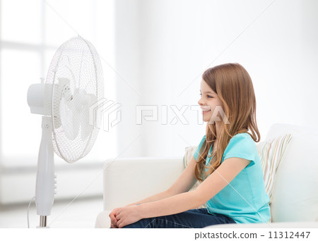 smiling little girl with big fan at home smiling little girl with big fan at home 11312447
