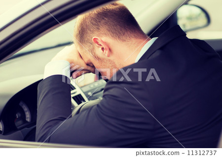 tired businessman or taxi car driver 11312737