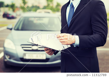 man with car documents outside man with car documents outside 11312789