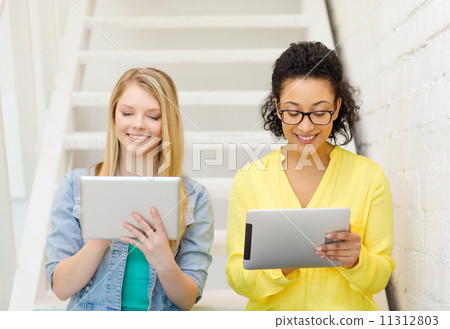 smiling female students with tablet pc computer smiling female students with tablet pc computer 11312803