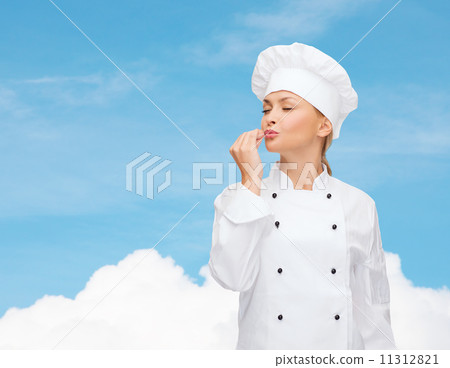 smiling female chef showing delicious sign smiling female chef showing delicious sign 11312821