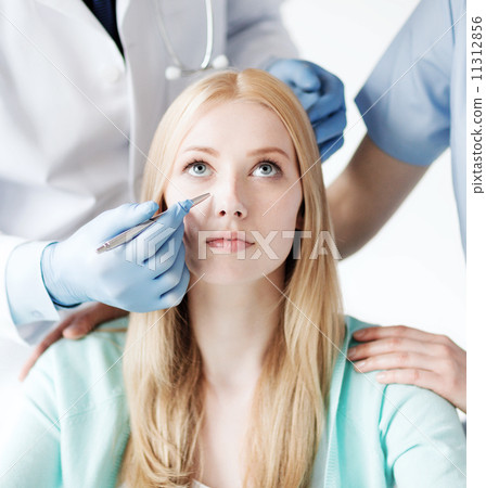 plastic surgeon and nurse with patient plastic surgeon and nurse with patient 11312856