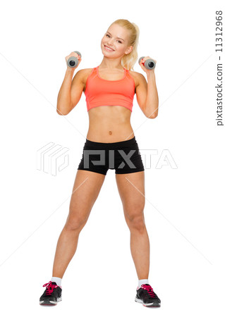 smiling beautiful sporty woman with dumbbells 11312968