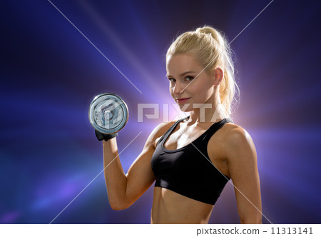 young sporty woman with heavy steel dumbbell 11313141