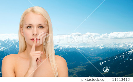 calm young woman with finger on lips calm young woman with finger on lips 11313413