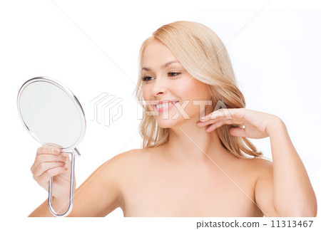 smiling woman looking at mirror smiling woman looking at mirror 11313467
