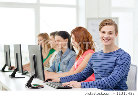 male student with classmates in computer class male student with classmates in computer class 11313482