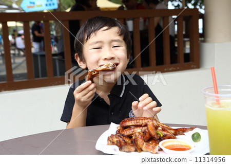 Boys eating chicken wings 11314956