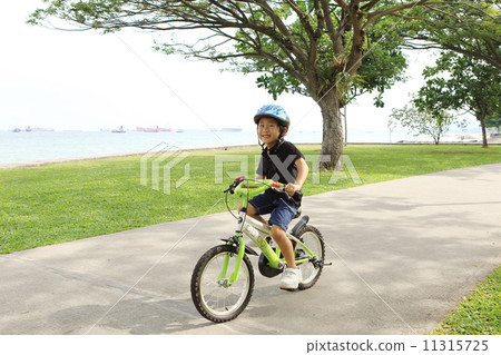 A boy riding a bicycle 11315725
