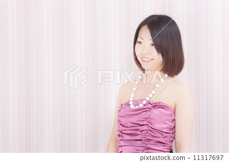 A woman in her 30's wearing a stylish party dress 11317697