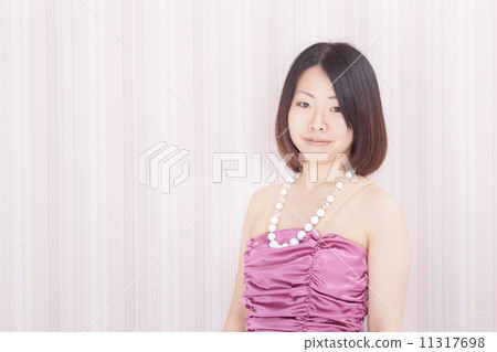 A woman in her 30's wearing a stylish party dress 11317698