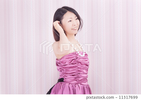 A woman in her 30's wearing a stylish party dress 11317699