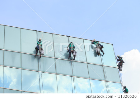 group of workers cleaning windows service on high rise building group of workers cleaning windows service on high rise building 11320526