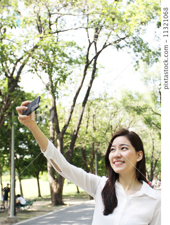 Close up portrait of Asian woman use mobile phone Close up portrait of Asian woman use mobile phone 11321068