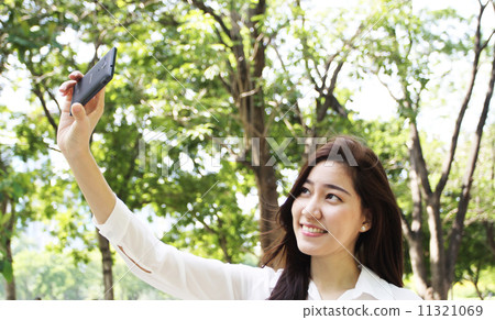 Close up portrait of Asian woman use mobile phone Close up portrait of Asian woman use mobile phone 11321069
