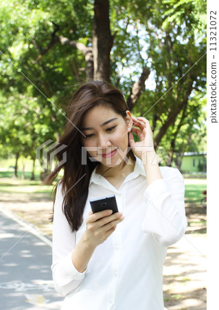 Close up portrait of Asian woman use mobile phone Close up portrait of Asian woman use mobile phone 11321072