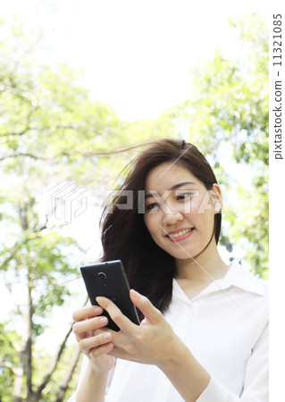 Close up portrait of Asian woman use mobile phone Close up portrait of Asian woman use mobile phone 11321085