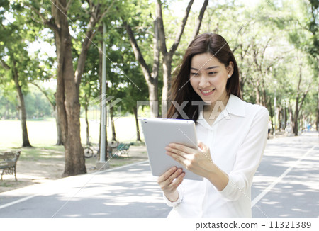 Close up portrait of Asian woman hold tablet Close up portrait of Asian woman hold tablet 11321389