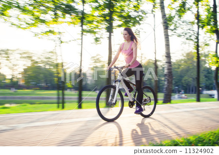 young woman on bicycle 11324902
