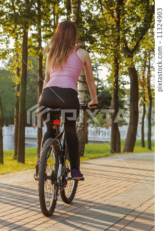 young woman on bicycle 11324903