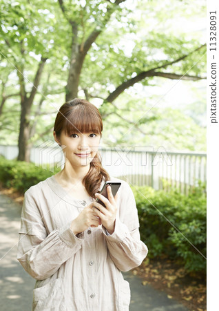 A woman using a mobile phone 11328091